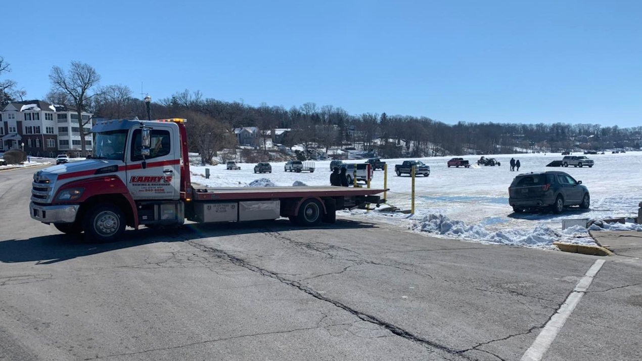 A tow truck pulls out a car that went through the ice Feb. 27, 2022 on Geneva Lake. Photo LGFD.