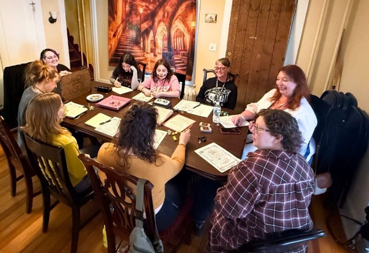 Heather Ashcraft runs an all-women tabletop role-playing game inside the historic 330 Center Street home in Lake Geneva, featuring two generations of the Gygax family and invited guests, with filmmaker Chris Moreland documenting the session.
