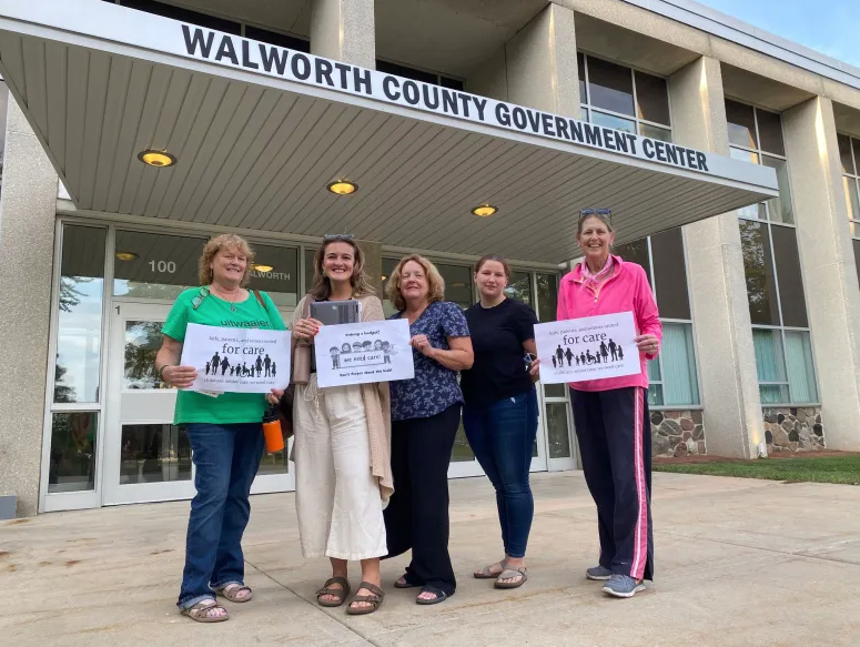 Members of Groundswell Collective gather outside a Walworth County building before attending a County Board meeting to advocate for the “Nursery to Nursing Home” campaign. (Courtesy of Groundswell Collective)